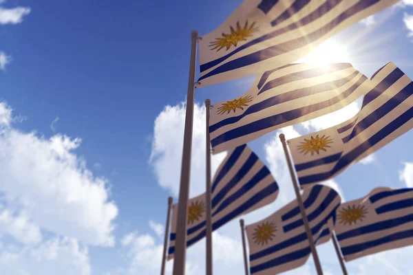 Уругвайські прапори розмахують вітром проти блакитного неба. 3D Рендерінг — стокове фото