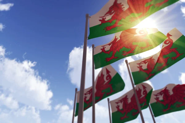 Vlajky Walesu vlající ve větru proti modré obloze. 3D vykreslování — Stock fotografie