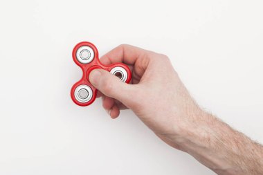 Erkek el, popüler hareketli döner oyuncağı tutuyor.