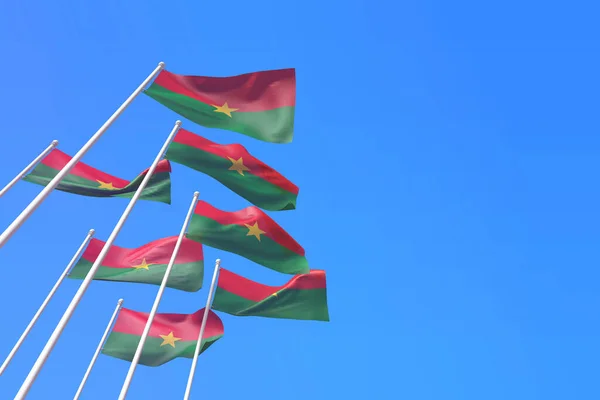Burikna Faso bayrakları mavi gökyüzüne karşı rüzgarda sallanıyor. 3B Hazırlama — Stok fotoğraf