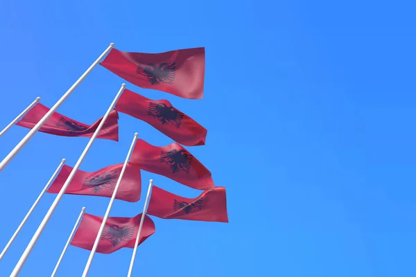 Bandeiras da Albânia acenando ao vento contra um céu azul. Renderização 3D — Fotografia de Stock
