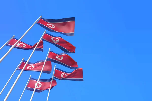 North Korea flags waving in the wind against a blue sky. 3D Rendering — Stock Photo, Image