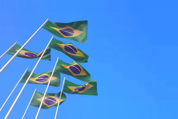 Brazilië vlaggen wapperen in de wind tegen een blauwe lucht. 3D-weergave — Stockfoto