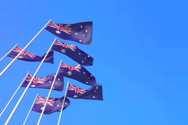 Σημαίες της Αυστραλίας κυματίζουν στον άνεμο πάνω σε έναν γαλάζιο ουρανό. 3D απόδοση — Φωτογραφία Αρχείου
