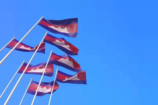 Οι σημαίες της Καμπότζης κυματίζουν στον άνεμο πάνω από έναν γαλάζιο ουρανό. 3D απόδοση — Φωτογραφία Αρχείου
