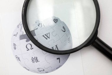 OXFORD, UK - FEB 16 2017: Wikipedia online encyclopedia logo printed on paper clipart