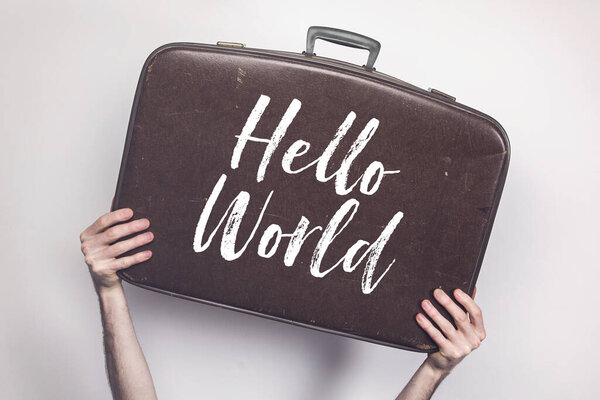 Hello World message on a vintage travel suitcase
