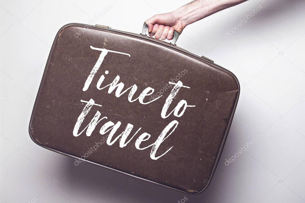 Time to travel to travel message on a vintage travel suitcase