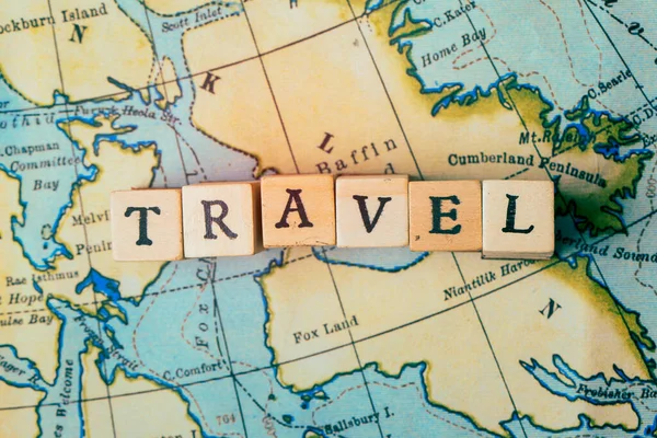 Travel word written in wooden blocks on a vintage travel map — Stock Photo, Image