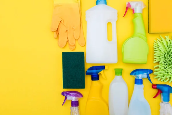 Limpieza de botellas de spray y tela yacía composición plana — Foto de Stock