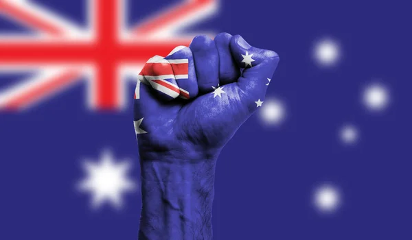 Australia flag painted on a clenched fist. Strength, Protest concept