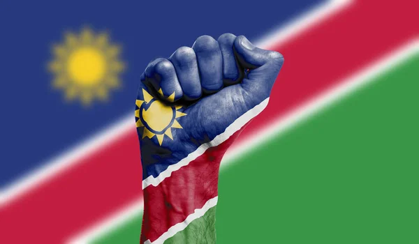 Namibia flag painted on a clenched fist. Strength, Protest concept — Stock Photo, Image