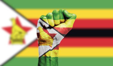 Zimbabwe flag painted on a clenched fist. Strength, Protest concept clipart