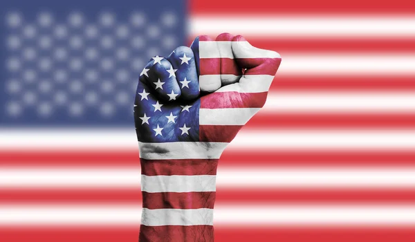 USA flag painted on a clenched fist. Strength, Protest concept
