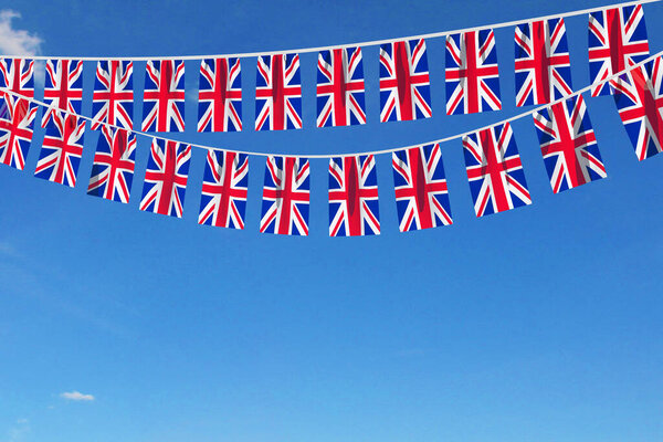 United Kingdom flag festive bunting hanging against a blue sky. 3D Render