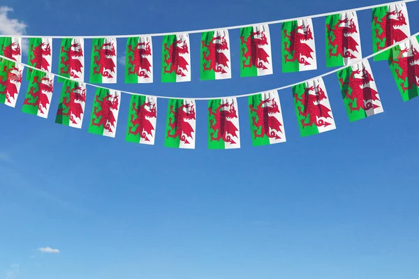 Wales flagga festliga bunting hängande mot en blå himmel. 3D-Render — Stockfoto