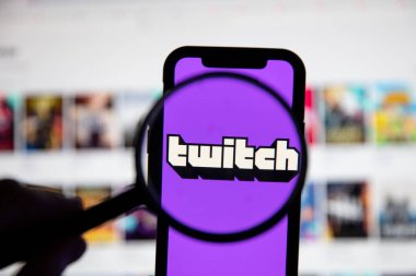LONDON, UK - April 30 2020: Twitch live gaming logo under a magnifying glass clipart