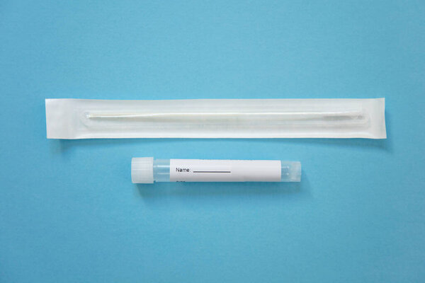 Virus testing swab and test tube on a blue background