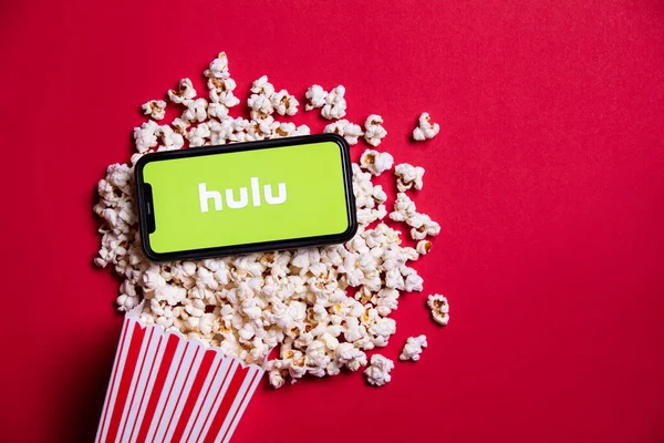 LONDON, UK - MAY 14 2020: Hulu logo on a smartphone with popcorn — Stock Photo, Image