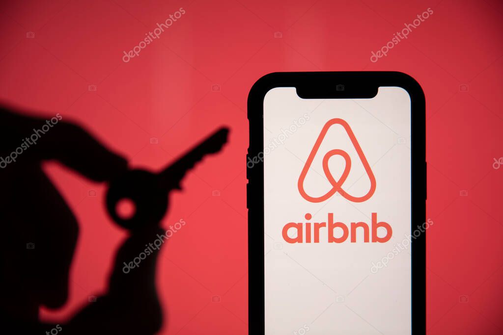 LONDON, UK - May 15 2020: Airbnb home rental logo on a phone with a key