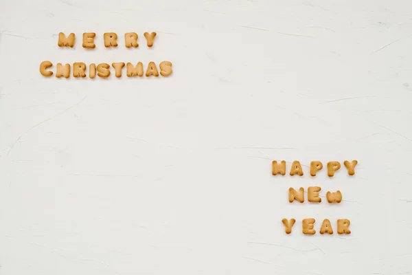 The words merry christmas and happy new year are written from co