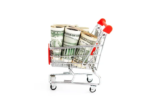 Red Mini shopping cart with US dollar money banknotes on white background. financial concept