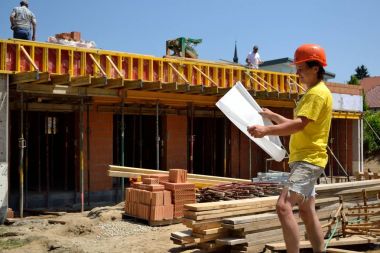 Construction foreman with plan on construction site clipart