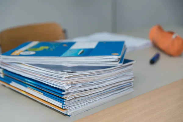 Exercise books on teacher's desk — Stock Photo, Image