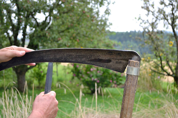 Person grinds scythe