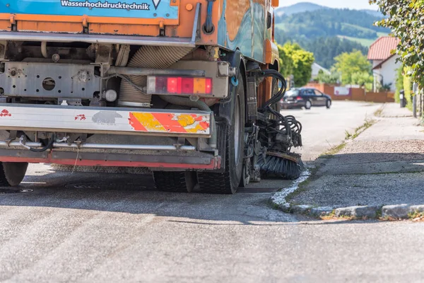 Wet street cleaning with sweeper - close-up — Stock Photo, Image