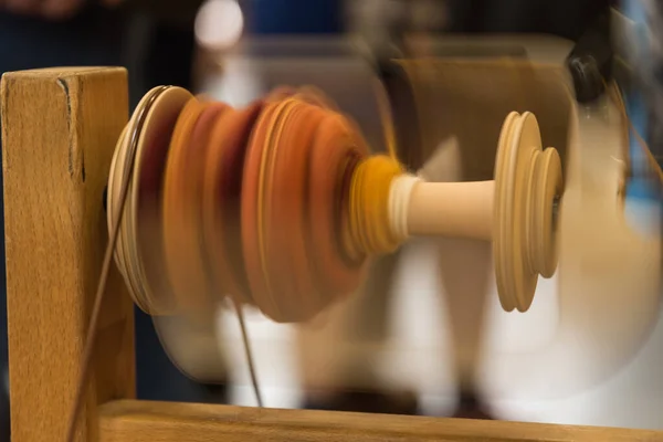 Spinning wheel spool makes fast turns to wind wool thread - spool wheel