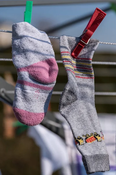 Children\'s socks hang with clothes pegs to dry - birth rate