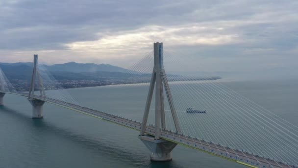 Aerial view of long cable-stayed Rio bridge in Greece at clouds weather, Ferry station — Stock Video