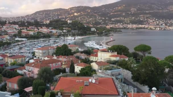France, Saint-Jean-Cape-Ferrat, 15 December 2019: Aerial view of most expensive place in French Riviera at sunset, terraces of country houses and estates, pools, Chaise lounges, pink clouds — Stock Video