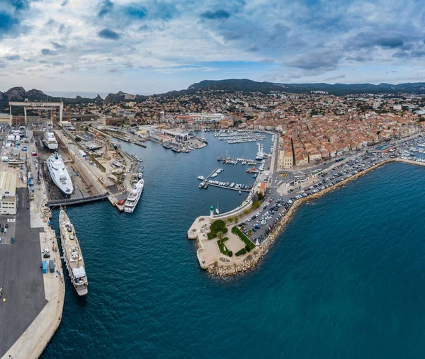 Vista aérea del muelle seco de mar en la ciudad de La Ciotat, Francia, la grúa de carga, barcos en reparación, un yate de vela de lujo y yate de motor, la montaña está en el fondo, astillero — Foto de Stock