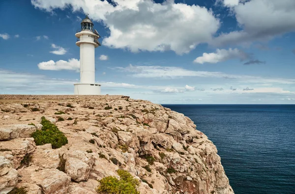 Leuchtturm auf Formentera, Spanien, blauer Himmel mit weißen Wolken, ohne Menschen, Felsen, Steine, sonniges Wetter — Stockfoto