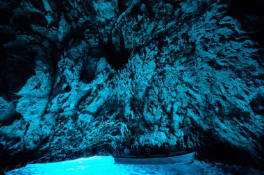 Bleu cave in Croatia, Croatian wonder, landmark. Tourist visiting the inside of the Blue cave, Bisevo island, light of blue color from water at midday clipart
