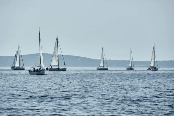 Beautiful sea landscape with sailboats, the race of sailboats on the horizon, a regatta, a Intense competition, bright colors, island with windmills are on background — Stock Photo, Image