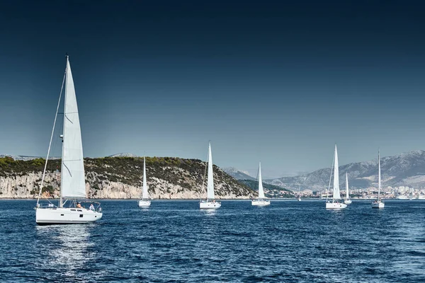 Beautiful sea landscape with sailboats, the race of sailboats on the horizon, a regatta, a Intense competition, bright colors, island with windmills are on background — Stock Photo, Image