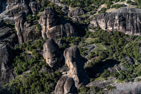 Aerial view of Unesco monument Meteora, the mountains, the landmark of Greek, sunny weather, fog, haze over a valley