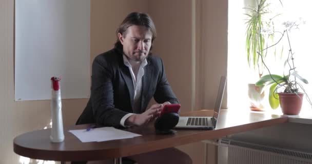 The businessman in a suit and without trousers stays at home, he works at the laptop, bottle of antiseptic, Holds conference, distant work during a pandemic Covid-19, quarantine — Stock Video