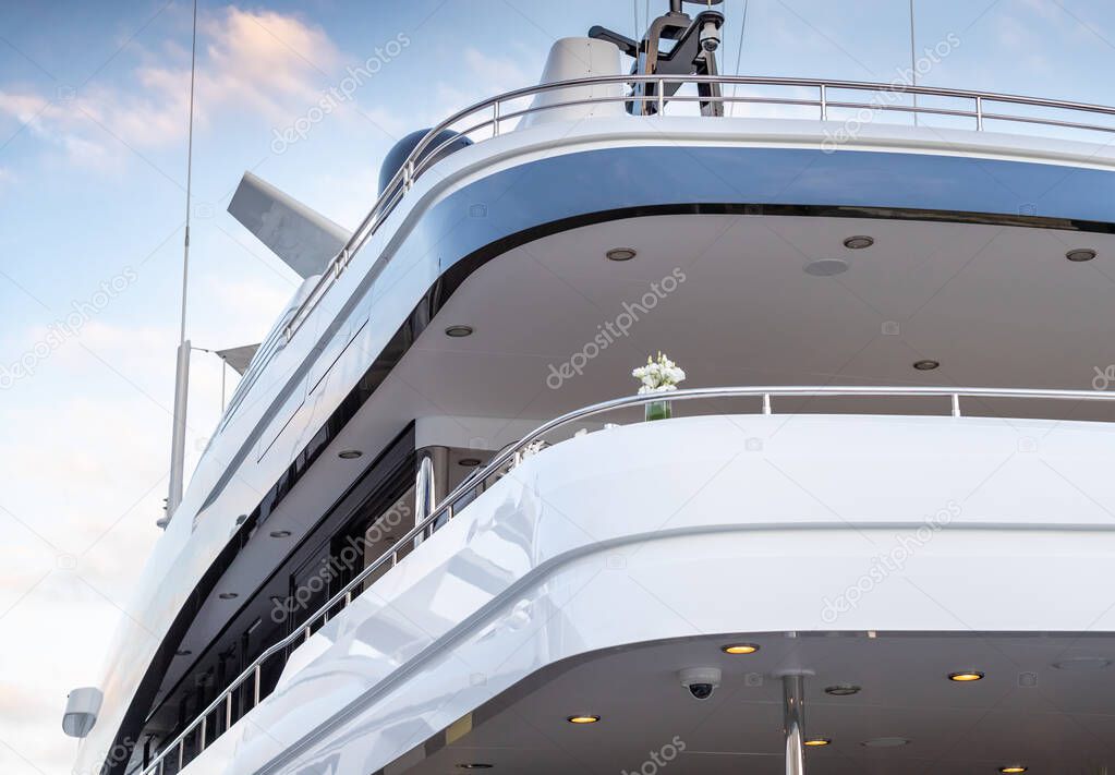 The top deck of a huge yacht at sunset, Glossy board of the boat, The chromeplated handrail, pink sky