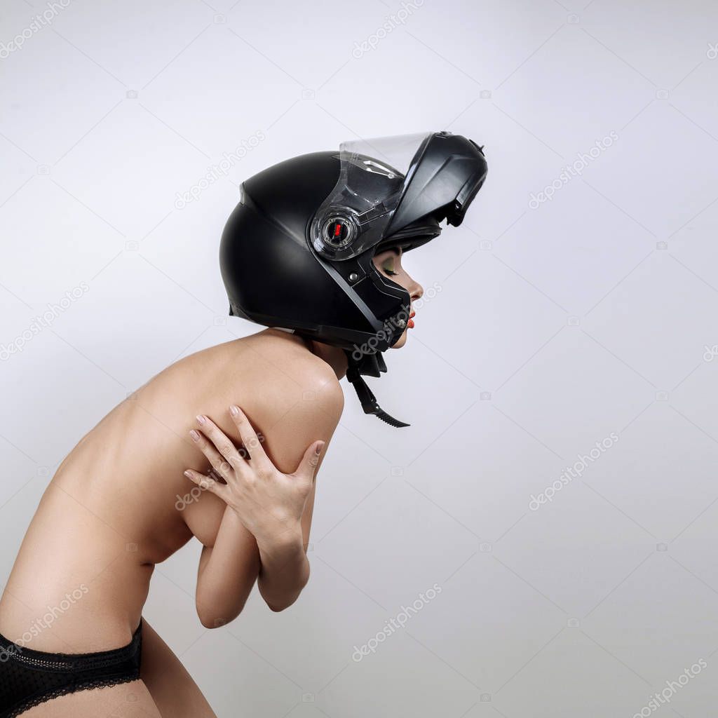 Naked girl in black motorcycle helmet