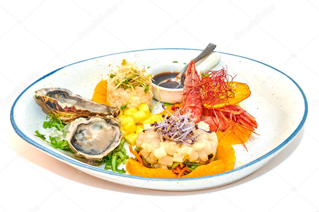 Mixed plate of raw fish, oysters and shrimp tartare