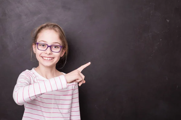 School - child girl (kid, pupil) pointing at the blackboard — Stock Photo, Image