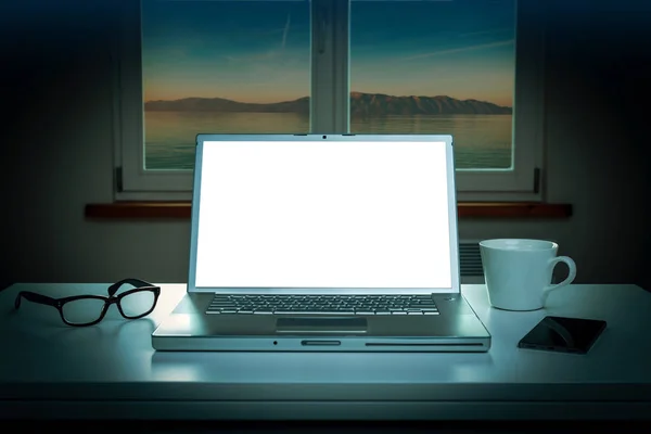Night - window and laptop computer with blank screen