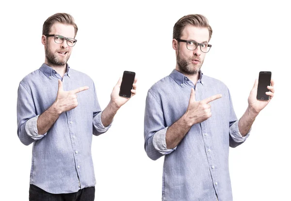 Man in blue shirt pointing at mobile phone (smartphone) — Stock Photo, Image