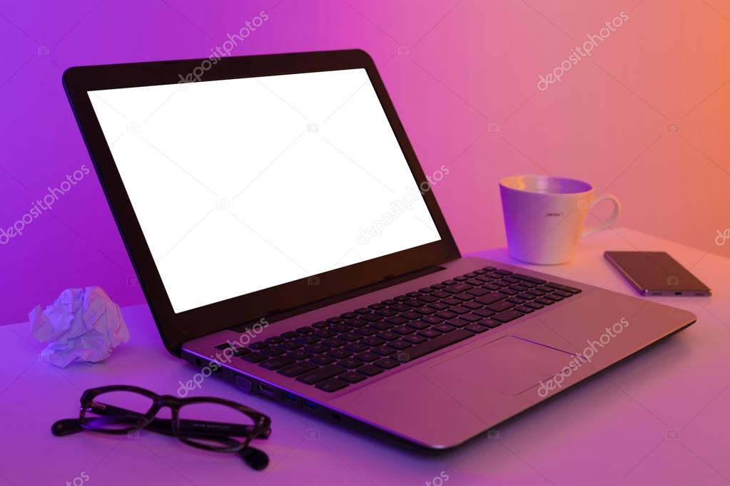 Colorful workplace - laptop computer with blank screen