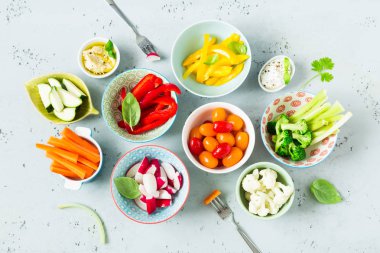 Vegetarian snacks - colorful vegetables and dips in bowls clipart