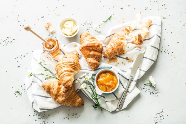 Croissants, jam, honey and butter - continental breakfast — Stock Photo, Image